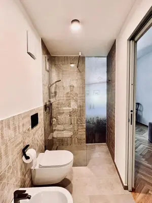 a bathroom with a toilet and a shower at Haus Noldin - historische Herberge - dimora storica in Salorno sulla Strada del Vino