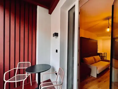 a room with a table and chairs and a bed at Haus Noldin - historische Herberge - dimora storica in Salorno sulla Strada del Vino