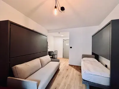 a living room with a couch and two large screens at Haus Noldin - historische Herberge - dimora storica in Salorno sulla Strada del Vino