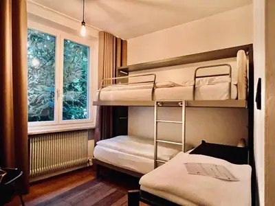 a room with two bunk beds and a window at Haus Noldin - historische Herberge - dimora storica in Salorno sulla Strada del Vino
