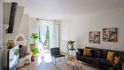 a living room with a black couch and a table at Appartamento Lichtenegg a Merano in Merano