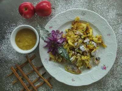 a plate with a red sauce and a blue flower at Hotel Reichegger in Villa Ottone