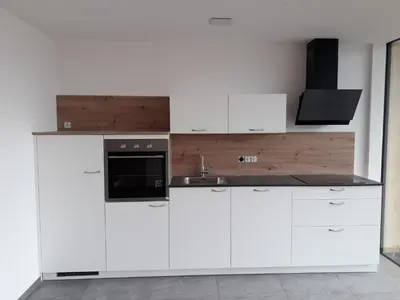 a kitchen with white cabinets and a sink at MESNERHOF CHALET - Ruhe, Rückzug & Südtiroler Charme mit kostenlosem Parken in der Tiefgarage in Bressanone