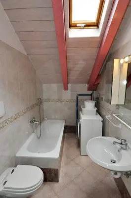 a bathroom with a tub and a toilet and a sink at Casa Azzurra in Pozza di Fassa