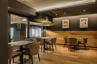 a bar in a room with wooden walls at Hotel Rosa Wellness & SPA in Vigo di Fassa