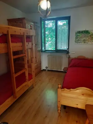 a bedroom with two bunk beds and a window at Finestra sul Cermis in Carano