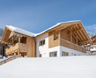 a house with a snow covered roof at Ciasa Nene Franzl in Badia