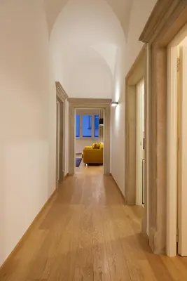 an empty hallway with a yellow couch in a room at Argentieri Apartment in Bolzano