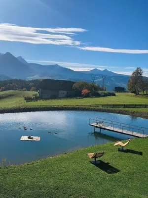 a white building with the sun shining on it at Oberschlichterhof in Longomoso