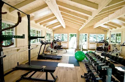 a gym with several treadmills and exercise bikes at Relais & Chateaux Hotel Castel Fragsburg in Merano