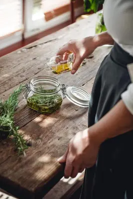 a person is preparing food on a wooden table at Relais & Chateaux Hotel Castel Fragsburg in Merano