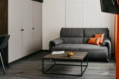 a living room with a couch and a coffee table at Nepomuk rooms in Vipiteno