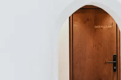 a wooden door with the word audiologist written on it at Nepomuk rooms in Vipiteno