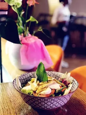 a plate of food on a table with a salad at Green Apartment in Bolzano