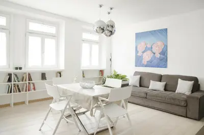 a living room with a table and a couch at Green Apartment in Bolzano