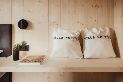 two white shopping bags sitting on a wooden counter at Villa Melitta in San Vigilio Di Marebbe