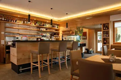 a bar in a restaurant with chairs and tables at Gasthof Weber in Petersberg
