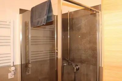 a shower with a glass door in a bathroom at Schneiderhof in Valdurna