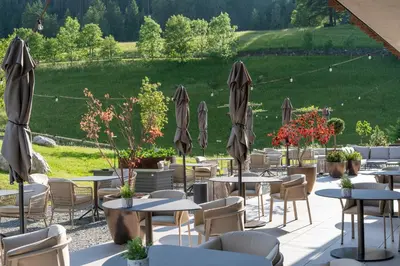 a restaurant with tables and chairs and umbrellas at Badia Hill in Badia