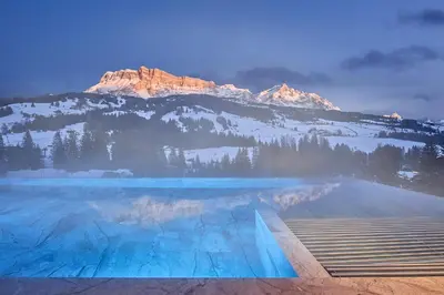 a swimming pool with a mountain in the background at Badia Hill in Badia