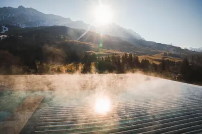 a hot spring with the sun in the background at Badia Hill in Badia