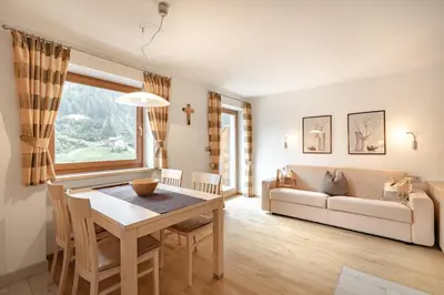 a living room with a table and a couch at Apartments Soval in Santa Cristina in Val Gardena