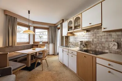 a kitchen with a table and a dining room at Apartment Ruiel in Santa Cristina in Val Gardena