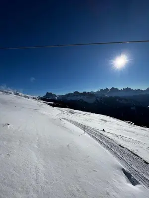 a snow covered road with the sun in the sky at Villa Silvia in Naz-Sciaves