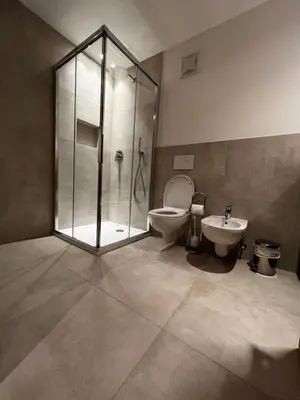 a bathroom with a shower and a toilet and a sink at Villa Silvia in Naz-Sciaves