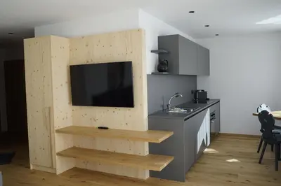 a kitchen with a tv on a wall with a counter at Villa Silvia in Naz-Sciaves