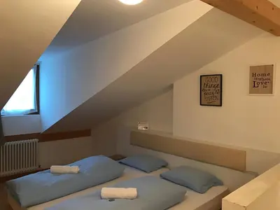 a bedroom with two beds in a attic at Argentieri Guesthouse in Bolzano