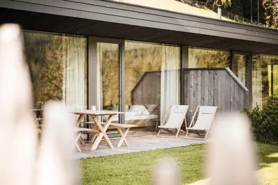 a patio with chairs and a table and a couch at Karerhof in Nova Levante