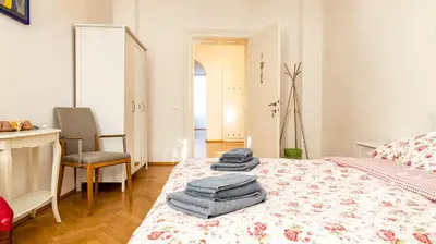 a bedroom with a bed with towels on it at Villa Anita Rooms in Bolzano