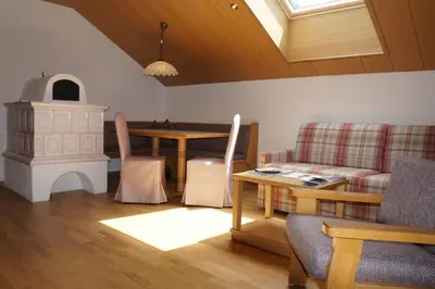 a living room with a table and a fireplace at Residence Cesa Callegari in Selva di Val Gardena
