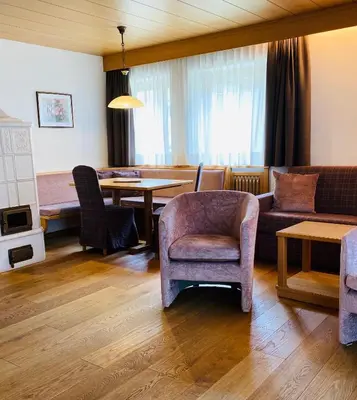 a living room with a couch and a table at Residence Cesa Callegari in Selva di Val Gardena