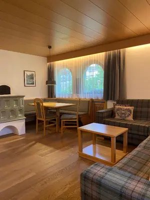 a living room with a couch and a table at Residence Cesa Callegari in Selva di Val Gardena