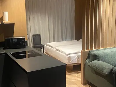 a small hotel room with a bed and a kitchen at Residence Cesa Callegari in Selva di Val Gardena