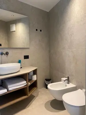 a bathroom with a white sink and a toilet at Residence Cesa Callegari in Selva di Val Gardena