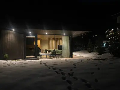 a house with footprints in the snow at night at Residence Cesa Callegari in Selva di Val Gardena