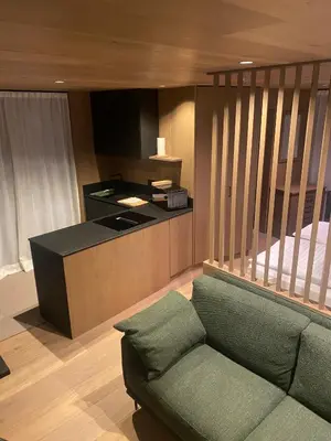 a living room with a couch and a kitchen at Residence Cesa Callegari in Selva di Val Gardena