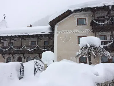 a building covered in snow in front at Residence Cesa Callegari in Selva di Val Gardena