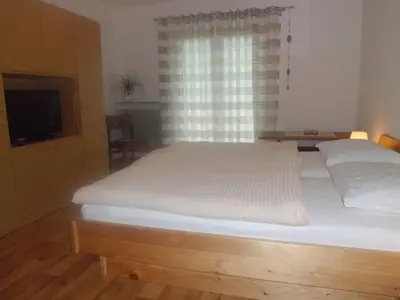 a large bed in a room with a window at Appartments Stoanegg in Parcines