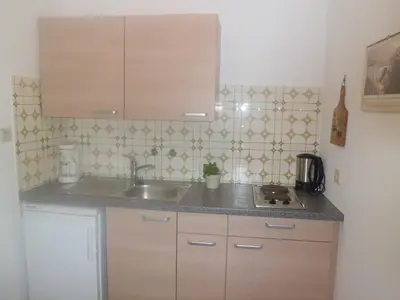 a kitchen with a sink and a counter top at Appartments Stoanegg in Parcines
