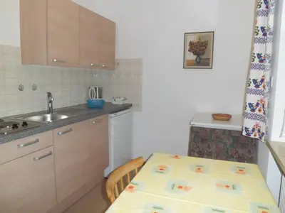 a small kitchen with a table and a sink at Appartments Stoanegg in Parcines