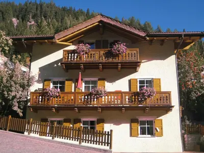 a building with flower boxes and balconies on it at Chalet Decrestina in Campitello di Fassa