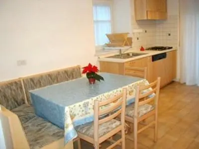 a living room with a blue couch and a tv at Chalet Decrestina in Campitello di Fassa