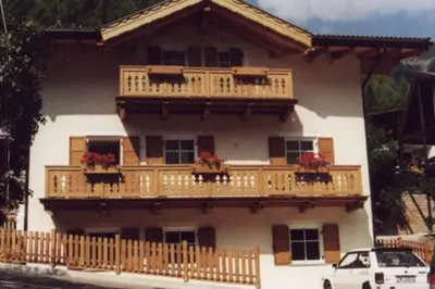 a living room with two couches and a table at Chalet Decrestina in Campitello di Fassa