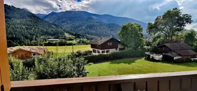 a view from a balcony of a village with mountains at Bilocale Nel Cuore Della Val Di Fiemme in Panchia
