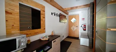 a bathroom with a counter with a sink and a washing machine at Bilocale Nel Cuore Della Val Di Fiemme in Panchia