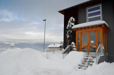 a pile of snow in front of a house at Hotel Villa Argentina Ronzone in Ronzone